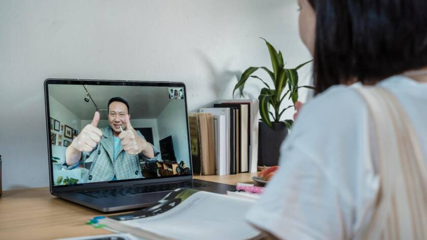 A student engaged in an interactive online class via video conference.